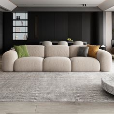 a living room filled with furniture and a large window in the center wall, next to a round coffee table