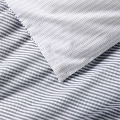 the bedding is made up with blue and white striped sheets