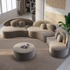 a living room filled with lots of couches and pillows on top of a rug