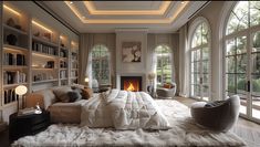 a large bedroom with a fireplace and lots of bookshelves in front of it