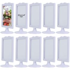 six white pedestal mirrors with flowers on them