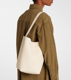 N/S Park Medium leather tote bag in white - The Row | Mytheresa Daily Use Beige Leather Bucket Bag, Modern Beige Leather Bucket Bag, Classic Cream Satchel Bucket Bag, Classic Cream Bucket Bag For Everyday Use, Luxury Cream Shoulder Bag With Leather Lining, Classic Beige Bucket Satchel, Luxury Beige Hobo Tote Bag, Beige Leather Bags For Work, Classic Cream Bucket Bag For Daily Use