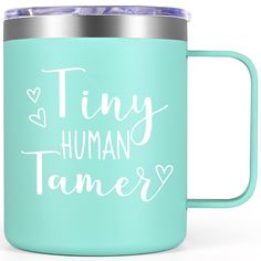 the words tiny, human tamer are written on a light blue coffee mug with silver lid