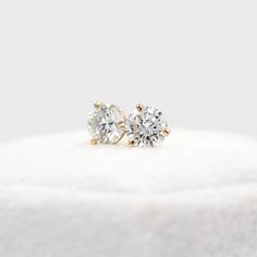 The perfect everyday stud, these three-pronged diamond earrings exude an elegant class and bring a stunning sparkle to the ear. Pictured with the Diamond Huggies. Details: 14k white, yellow, or rose gold, or platinum 1.03ct total weight — lab-grown diamonds *All diamonds are E-F color and VVS-VS clarity Timeless Rose Gold Diamond Earrings, Timeless Yellow Gold Diamond Earrings With Brilliant Cut, Classic Round Cut Earrings For Everyday Luxury, Timeless Solitaire Cubic Zirconia Diamond Earrings, Classic 14k Gold Diamond Earrings With Prong Setting, Classic Yellow Gold Diamond Earrings With Prong Setting, Minimalist Solitaire Diamond Earrings, Rose Gold 14k Brilliant Cut Diamond Earrings, Classic Gold Moissanite Diamond Earrings