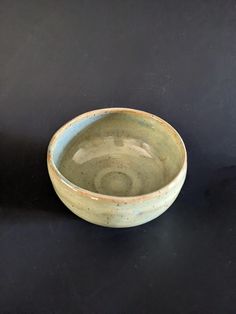 a small bowl sitting on top of a black table