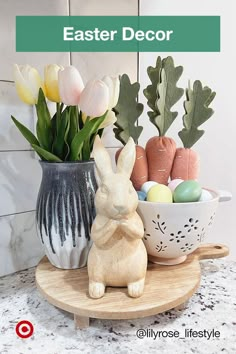 an easter decoration with flowers, eggs and bunny figurines on a counter top