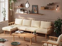 a living room filled with lots of furniture next to a wall mounted clock and potted plants