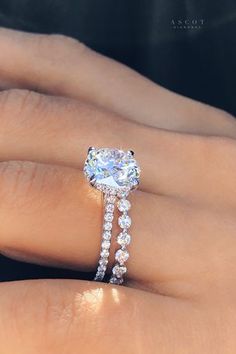 a woman's hand with a diamond ring on it