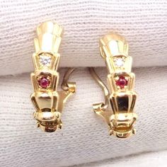 About This Piece: Metal: 18k yellow gold  Measurements: 15mm x 16mm x 5mm  Weight: 6.3 grams  Stones: 2 round brilliant cut diamonds VVS1 clarity, E color total weight approx. .05ct 2 round cabushon rubys  Hallmarks: Ch Dior 750 007 Dior Earrings, Ruby Earrings, Round Brilliant Cut Diamond, Brilliant Cut Diamond, Round Brilliant, Christian Dior, Gold Diamond, Diamond Cuts, Vintage Jewelry