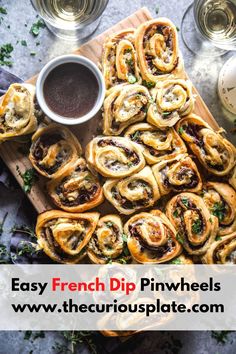 the french dip pinwheels are ready to be eaten with dipping sauce on top