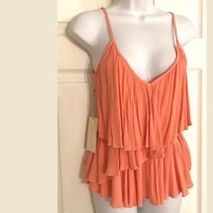 This Is An Awesome Double Zero Cami Tank Top. It Has A Coral Pink/Orange Crinkle Material, Adjustable Straps, Side Zipper And Tiered Style. Looks Super Cute With Cutoff Denim Shorts. New With Tags. Size: Small Bin J100 Summer Orange Ruffle Tops, Orange Ruffled Summer Top, Summer Orange Ruffled Tops, Orange Sleeveless Ruffled Top, Orange Flowy Top For Summer, Flowy Orange Summer Top, Orange Ruffled Top For The Beach, Orange Ruffled Top For Beach, Pink Spaghetti Strap Top For Vacation