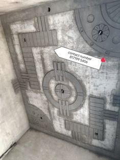 a room with concrete walls and a red arrow pointing to the center