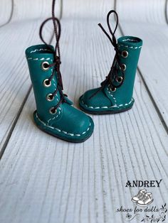 a pair of baby boots with laces on them