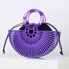 a purple purse sitting on top of a white table