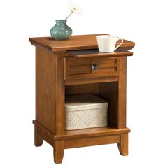 a wooden night stand with a drawer and a cup on top of it, against a white background