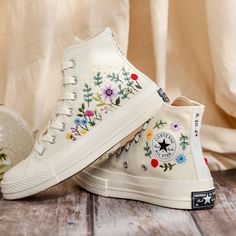 Custom Bridal Flowers Embroidered Sneakers for Wedding, Flowers Embroidered Converse for Bride, Flowers Embroidered Shoes Custom, Wedding Gifts 💚 Immerse yourself in the intricate craftsmanship as we lovingly hand embroider rustic flowers onto your chosen Converse pair 💚 🌿 The listed price encompasses both the Converse Shoes and the showcased Embroidery Designs. 1. MANUFACTURING PROCEDURE 🌿 Upon receiving your order, we initiate the shoe preparation process. If your chosen shoes are readily White Lace-up Sneakers With Appliques, Embroidered Closed Toe Sneakers For Spring, Embroidered Sneakers For Spring, White Sneakers With Appliques For Summer, Spring Embroidered Sneakers, Spring Embroidered Canvas Shoes With Round Toe, Spring Wedding Embroidered Sneakers, High-top Multicolor Embroidered Sneakers, High-top Embroidered Multicolor Sneakers