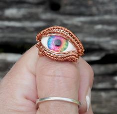 This eyeball ring has lifelike depth and has been wrapped in curvy copper wire.  This unique rainbow evil eye ring will catch compliments where ever you go and is sure to become your favorite piece of jewelry! This ring is perfect for the dark academia or cottagegore look.  I handcraft these rings myself, right here in the USA, and I love watching each eye come to life in the process.  I make them with beauty and durability in mind, if you have any questions at all, please get in touch! You will Googly Eye Rings, Eyeball Ring, Academia Jewelry, Rainbow Evil Eye, Dark Academia Jewelry, Copper Eye, Jewelry Evil Eye, Evil Eye Ring, Ring Pictures