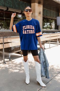 Cheer on your Florida Gators in style with our oversized v-neck fashion jersey, embellished with rhinestone-stripe trims along the sleeves. Designed to make fans stand out from the crowd. Fall Sports V-neck Tops, Oversized V-neck Top For College, Sporty Oversized V-neck Top, Oversized Sporty V-neck Top, Fall College V-neck Tops, Fall V-neck Tops For College, Trims Fashion, Kentucky Wildcats, Florida Gators