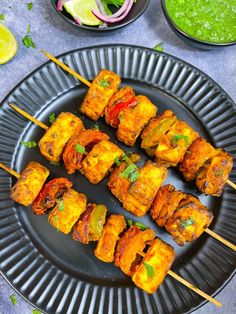 chicken and vegetable kabobs on a black plate with text overlay that reads air fryer paneer tikka