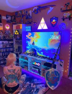 a person sitting in front of a tv playing video games on the nintendo game console