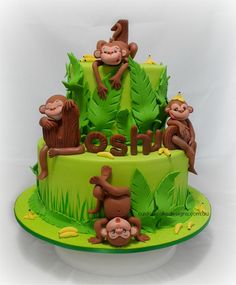 a three tiered cake with monkeys on it