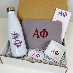 a white water bottle sitting in a box next to coasters and an ashtray