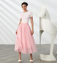 Look your best in the Prestigious Tulle Pleated Flowy Maxi Skirt. This lightweight and comfortable skirt is crafted from soft tulle that is pleated for maximum comfort. Its flowy skirt design adds a touch of class and elegance to your wardrobe. Perfect for formal occasions or everyday wear. 100% Polyester Imported Elegant pleated design: This pleated skirt features a beautiful pleated design that creates a flowing, elegant silhouette. The pleats are evenly spaced and give the skirt a luxurious t Fitted Tulle Pleated Midi Skirt, Feminine Sheer Skirt For Parties, Feminine Pleated Tulle Skirt, Feminine Full Tulle Skirt, Sheer Feminine Skirt For Spring, Chic Pink Tulle Maxi Skirt, Feminine Sheer Skirt For Spring, Spring Tulle Flared Pleated Skirt, Spring Tulle Pleated Flared Skirt