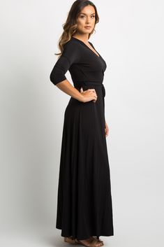 Details A solid hued maxi dress featuring a wrap v-neckline, elastic cinching under the bust, 3/4 sleeves, and belt loops with a sash tie. Content + Care 95% Polyester 5% Spandex Hand Wash Cold, No Bleach, Hang or Line Dry USA Size + Fit Length: 59" Sleeve Length: 11.5" Measured From: Small Product Code: 15878 Model Stats: Height: 5'9" Bust: 34" Hips: 37" Wearing Size: Small Concert Dresses, Tie Maxi Dress, Tie Shop, Guest Dress, Pink Blush Maternity, Black Solid, Xl Dress, Wedding Guest Dress, Wedding Guest