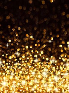 an abstract gold background with sparkling lights