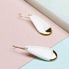 White earrings are handmade from porcelain and hand painted with 24 k gold luster. Perfect earrings to match your daily and occasion wear. Lightweight and very comfortable, you won't feel that you are wearing anything at all. Handmade 14 k gold-filled hooks are high quality - safe for most people with allergies and doesn't change colour after time. Minimalist jewelry that will add unusual detail to your style. Unique design earrings and great idea for gift. More designs avaliable: https://www.et Everyday Single Enamel Earring, Handmade White Enamel Earrings, White Modern Drop Earrings, Modern White Drop Earrings, Minimalist White Teardrop Earrings, Modern Gold Earrings With Enamel, Modern Gold Enamel Earrings, Everyday Gold Enamel Earrings, White Minimalist Teardrop Dangle Earrings