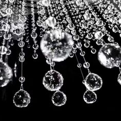 water droplets are hanging from the ceiling in this black and white photo, with bubbles floating down