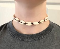 "This cowry shell choker is perfect for vacations and everyday wear. This choker is a summer statement piece. It's 14\" with an adjustable string that adjusts the choker to 27\". This choker has fresh water cowry shells and a black wax cord. It usually takes me 1-3 business days to make your order. Depending on where you live, it will take around 1-4 weeks to get your order shipped to you. Thanks in advance!" Cowry Shell, Shell Choker, Choker Necklaces, Adjustable Necklace, Statement Pieces, Fresh Water, 10 Days, Necklace Etsy, Choker