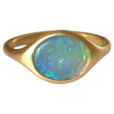 Dalben design 18k yellow gold satin finishing ring with a 1 carat bezel-set oval shape Australian crystal opal . Ring size US 6 - EU 51 re-sizable to most finger sizes. Bezel setting dimension: width 11 mm, height 9,2 mm. The ring has been designed and handcrafted in our atelier in Italy Como with a rigorous quality workmanship .