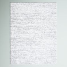 a white wall hanging on the side of a gray wall