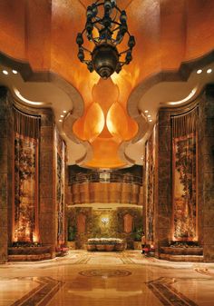 an ornate lobby with marble columns and chandeliers