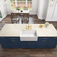 a kitchen with blue cabinets and marble counter tops