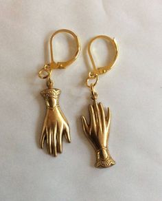 A pair of mixed matched elegant hands two hand earrings created from two Victorian styled findings raw brass gold tone charms For pierced ears with leverback fittings Perhaps a present for an engagement or wedding with the emphasis on hands in both celebrations.  Please note that the hands are identical and therefore not a true 'pair' of hands.  These earrings hang one from the fingers, and the others hang from the cuff, so it is like giving someone a hug I also have earrings that both hang from the fingers, or a pair that both hang from the cuffs Raw brass has all the colour of 9ct gold without the price tag The charms are single sided stamped metal and are therefore hollow backed and lovely and light to wear Please note these are vintage findings so I haven't polished them as some purcha Antique Gold Brass Jewelry With Lobster Clasp, Hand-cast Brass Jewelry For Anniversary, Gold Brass Jewelry With Lever Back, Hand Cast 14k Gold Jewelry, Hand-cast Brass Dangle Earrings, Gold Hand Cast Dangle Earrings, Bronze Brass Jewelry With Lobster Clasp, Brass Jewelry With Lever Back For Gift, Victorian Brass Jewelry With Lobster Clasp