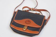 "Vintage 90s Dooney & Bourke leather crossbody purse. Has a little bit of wear on the end of the leather strap as shown in picture #2, other than that in good used shape. Zipper pocket inside, 1 big pocket on the outside back. Measures : 10.5\" wide, 8\" tall, Strap : about 45\"" Crossbody Purse Designer, Dooney And Bourke Handbags, Vintage Dooney And Bourke, Vintage Style Earrings, Big Pocket, Etsy Products, Dooney And Bourke, Leather Crossbody Purse, Victorian Jewelry