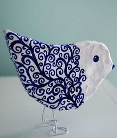 a blue and white bird sitting on top of a table