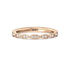 a rose gold wedding band with white diamonds