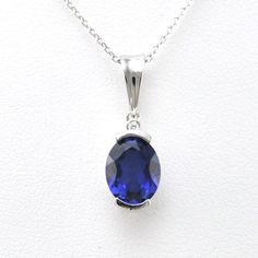 Lab grown sapphire 7x9mm oval cut gemstone is set in a sterling silver pendant setting with a rhodium finish. Rhodium protects the silver from oxidizing quickly as well as gives the appearance of white gold. Cubic zirconia accent enhances the pendant design on the top of the design. Pendant comes on an 18 inch long cable chain. Style Number: 19568 Metal: 925 Sterling Silver Gemstone: Lab Grown Sapphire Dimensions: 13/16 inch long and 1/4 inch wide, 18 inch chain Roman Glass Jewelry, Art Glass Jewelry, Cz Necklace, Southwestern Jewelry, Shell Jewelry, Amber Jewelry, Sapphire Necklace, Glass Gifts, Sea Glass Jewelry