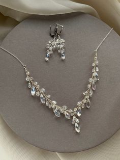 "This jewelry set features a wonderful necklace and earrings, that will definitely make you feel extraordinary on your special day. Delicate necklace in this set features sparkling clear  crystals elegantly strung on delicate silver wire. The earrings mimic the same fabulous style as the necklace with all the same crystals. This set would look outstanding with any classic or modern wedding dress. Made of silver plated base with tarnish resistant coating - premium jewelry material, non allergenic Sparkling Clear Jewelry For Wedding, Clear Sparkling Jewelry For Wedding, Elegant Clear Jewelry With Sparkling Stones, Diamond White Crystal Jewelry Sets With Matching Earrings, Formal Clear Crystal Jewelry, Wedding Jewelry With Matching Clear Earrings, Elegant Sterling Silver Rhinestone Necklace For Wedding, Dazzling Crystal Sparkling Jewelry Sets, Sparkling Crystal Jewelry Sets