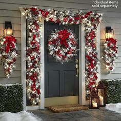 christmas wreaths and lights on the front door of a house