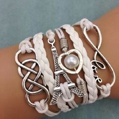 So Fun And Boho This Braided Rope Design Bracelet Features Charms Like The Eiffel Tower, Infinity Symbol And A Silver Tone Heart Encircling A Faux Pearl.Each Held In Place By This Lovely Braided Rope. Fun, Boho, Trendy Look With Denim Or Beachwear Trendy Adjustable White Jewelry, Trendy White Bangle Jewelry, Adjustable White Charm Bracelet For Friendship, Casual White Adjustable Charm Bracelet, Everyday White Metal Jewelry, Elegant White Bracelets For Friendship, Casual White Metal Jewelry, White Metal Charm Bracelet As A Gift, White Metal Charm Bracelet As Gift