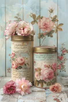 two jars with flowers on them sitting next to each other