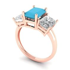 three stone ring with blue topaz and white side stones in rose gold plated setting