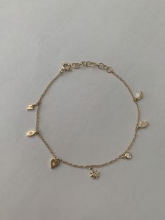 "This dainty yet sturdy charming charm bracelet is the perfect bracelet to layer with other bracelets or just to wear by itself. * 14K Yellow Gold * Approx. Diamond Weight: 0.07cts * Adjustable length: 6\"-7\" *Necklace also available: https://www.etsy.com/listing/510314824/14k-gold-tiny-charm-necklace Upgrades for FedEx/UPS guaranteed 2-day delivery are available and can be selected prior to checkout without separate invoicing. It is generally not an issue, but the USPS cannot guarantee deliver Minimal Charm Bracelet, Bracelet Charms Gold, Cute Everyday Bracelets, Bracelet Dainty, Charm Bracelet Dainty, Gold Bracelet With Charms, Gold Charms For Bracelets, Aesthetic Gold Bracelets, Gold Dainty Charm Bracelet