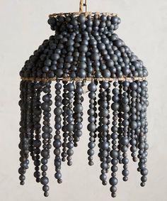 a chandelier made out of beads hanging from a rope