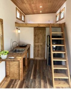 a kitchen and stairs in a tiny home