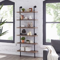 a living room filled with furniture next to a window and a plant on top of a wooden shelf